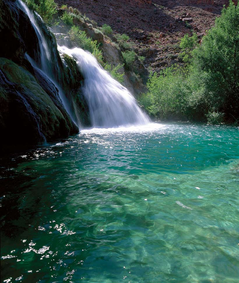 In Havasu Canyon, Navajo Falls skims 75 feet down mossy rocks into a blue-green pool before tumbling over Havasu and Mooney falls en route to the Colorado River.