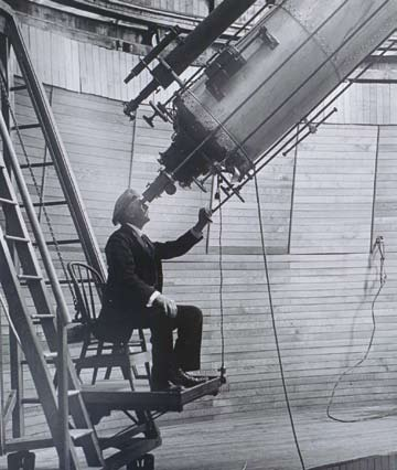 Lowell Observatory founder Percival Lowell peers through the Clark Telescope.