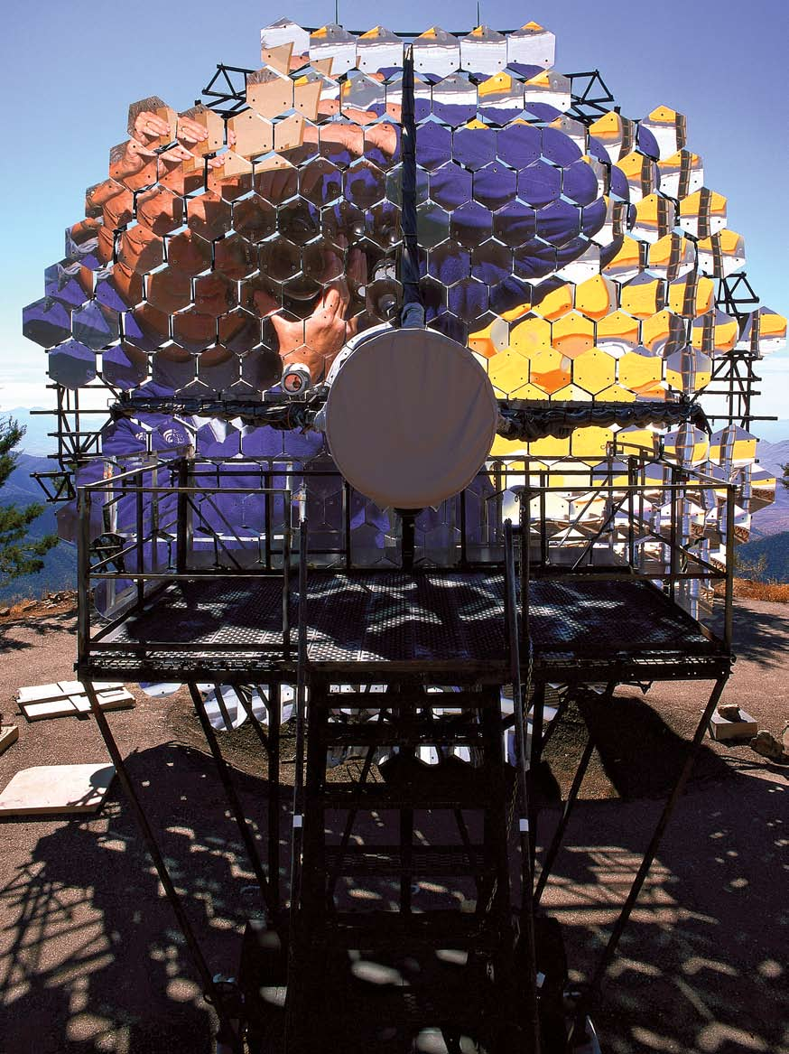 Photographer David H. Smith's reflection captured in the mirrors of the Fred Lawrence Whipple Observatory's optical reflector provides a graphic visual display of its light-collecting capabilities.