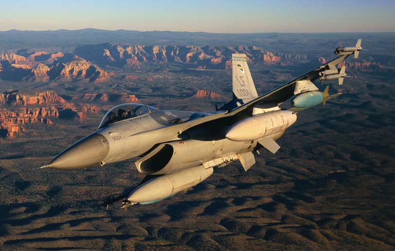 An F-16 makes a high-speed turn in the clear skies over Sedona. All the F-16 pilots in the Air Force undergo their six months of advanced fighter training at Luke Air Force Base.