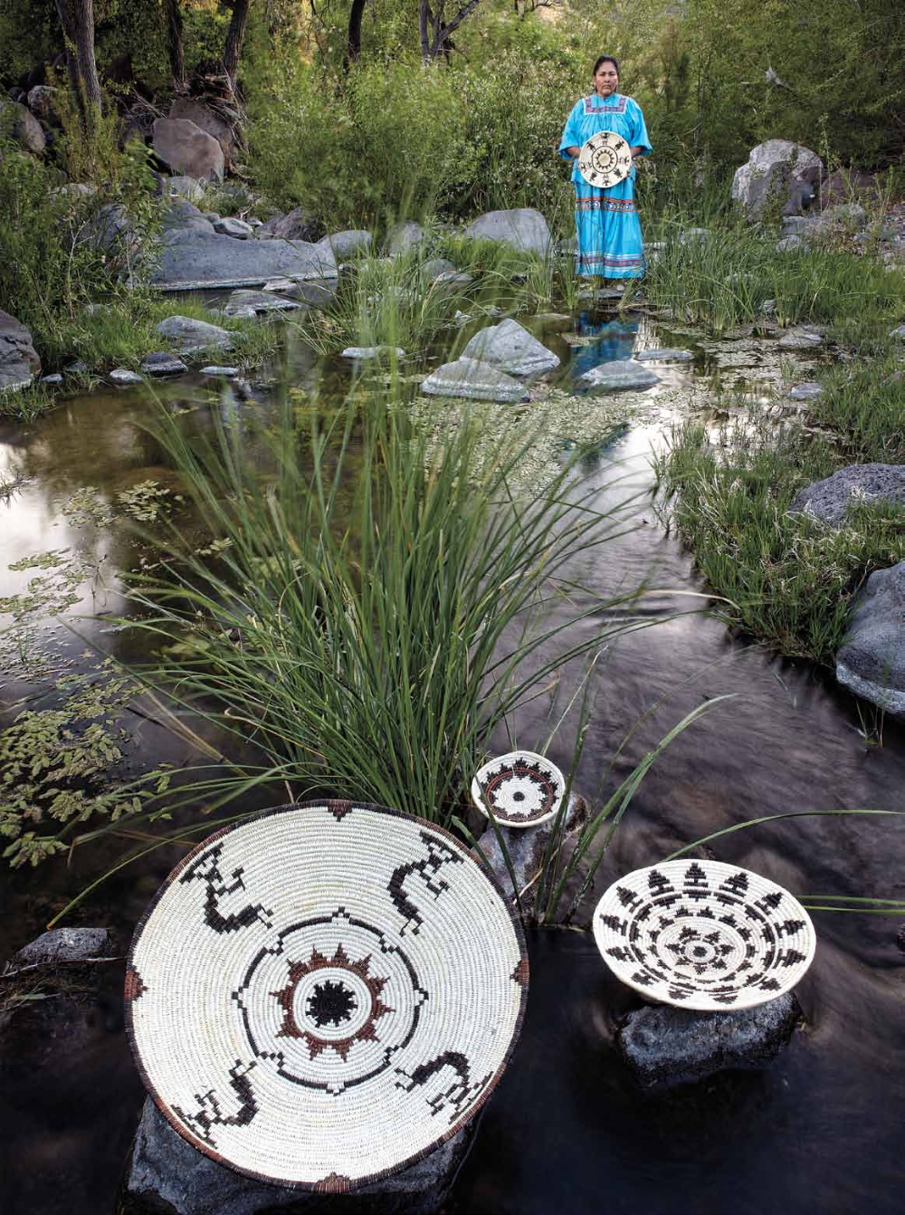 Teri Goode poses with some of her baskets on the San Carlos Apache Reservation.