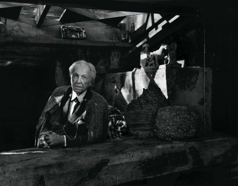 Frank Lloyd Wright - photographed here at Taliesin West, his winter home from the late 1930s to his death in 1959-seldom appeared without his immaculate suit and tie, and he sometimes wore a cape as well. He cultivated this theatrical image as carefully as he designed the entry sequences to his buildings.