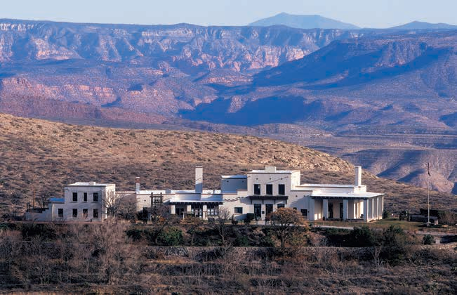 The view from the base of Cleopatra Hill sweeps from the James S. Douglas mansion of Jerome State Historic Park across the Verde Valley to Sedona's red rocks and to the San Francisco Peaks in the far distance.