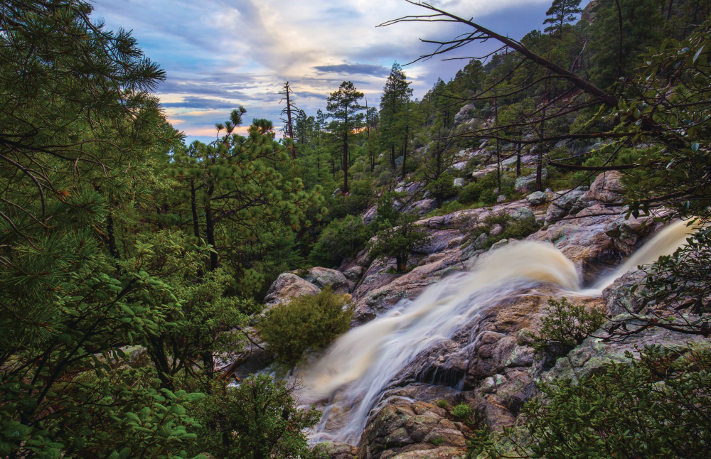 A waterfall flows over weathered rocks in Palisade Canyon, part of the Tucson area’s Santa Catalina Mountains. Exploring this remote canyon is a challenge that often involves technical canyoneering and rappelling. | Joel Hazelton | CANON EOS 6D, 1/10 SEC, F/16, ISO 200, 19 MM LENS