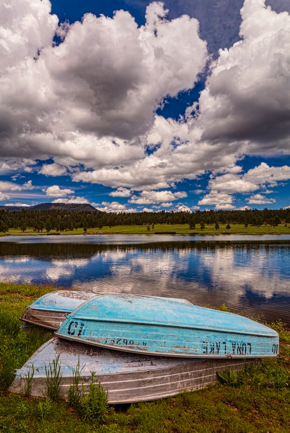 Old rowboats mark the shoreline of Luna Lake, near Alpine, as monsoon clouds gather above. When full, Luna Lake has a surface area of about 75 acres. | Claire Curran