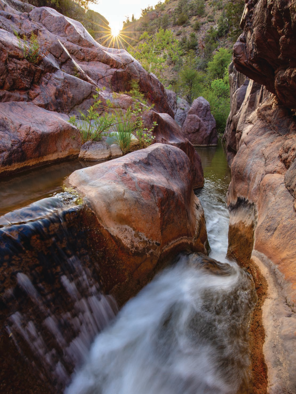 Late-afternoon sun punctuates a view of a slick-rock cascade in a narrow section of Haigler Creek, part of Central Arizona’s Hellsgate Wilderness. Six trailheads provide access to this inhospitable wilderness area, which covers more than 37,000 acres and is managed by the U.S. Forest Service. | Joel Hazelton | CANON EOS 5DS R, 0.3 SEC, F/16, ISO 100, 16 MM LENS