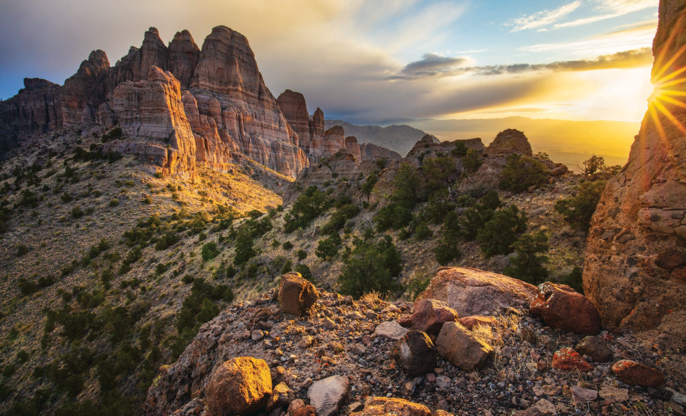 Dramatic formations in the Mount Tipton Wilderness, northwest of Kingman, glow at sunrise as a spring storm passes overhead. This topographically challenging, 31,000-acre wilderness area offers numerous opportunities for hikers, equestrians and photographers. | Joel Hazelton | CANON EOS 5DS R, 1/30 SEC, F/16, ISO 100, 16 MM LENS