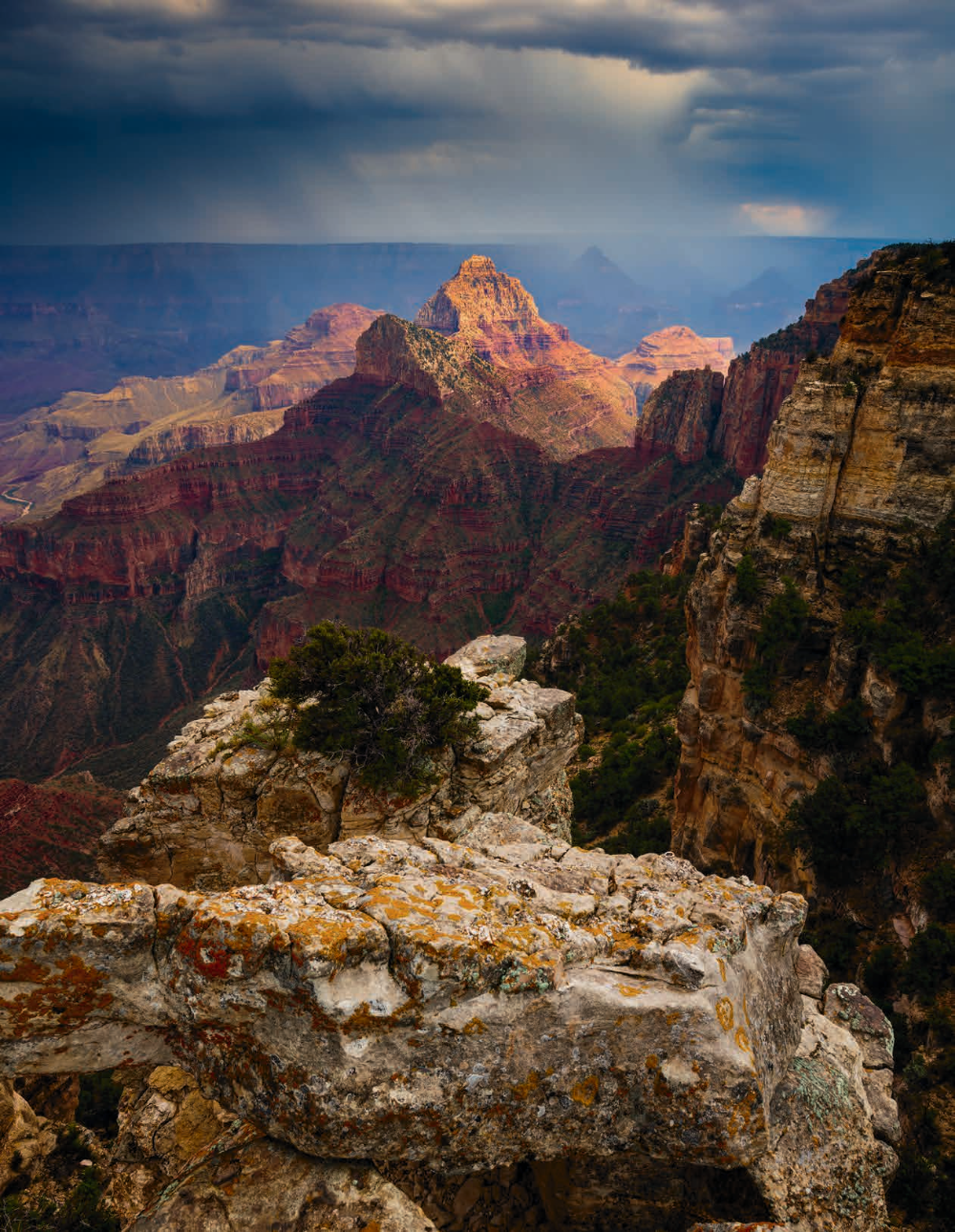 An overlook on the North Rim offers a view of Vishnu Temple and rainfall from a monsoon storm. The summer monsoon, from mid-July through the end of September, is when afternoon thunderstorms at the Canyon are most common. CANON EOS 5DS R, 1/10 SEC, F/11, ISO 100, 20 MM LENS