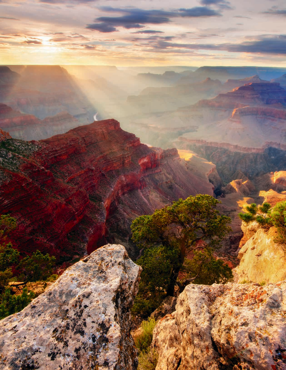 An evening view from Hopi Point, on the South Rim, includes light streaming into the Canyon and a glimpse of the Colorado. Hopi Point is along the Hermit Road, which is open to private vehicles from December through February and to Grand Canyon National Park shuttles at other times of the year. CANON EOS 5D MARK II, 0.4 SEC, F/16, ISO 100, 14 MM LENS