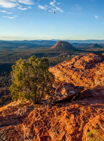 Another overlook on the trail includes a glimpse of hot air balloons and distant mountains.