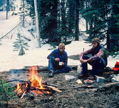 On the North Rim of the Grand Canyon, the Gillenwaters take advantage of a snowless spot to savor a warm fire and a cup of hot chocolate. They’d said goodbye to the mules and Little Boogie on the South Rim.
