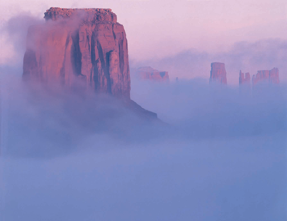 Fog shrouds Merrick Butte (foreground) and other iconic formations in Monument Valley, a Navajo Nation tribal park that attracts some 500,000 visitors annually. Merrick Butte is named for Jack Merrick, who prospected for silver in the area in the late 1800s.