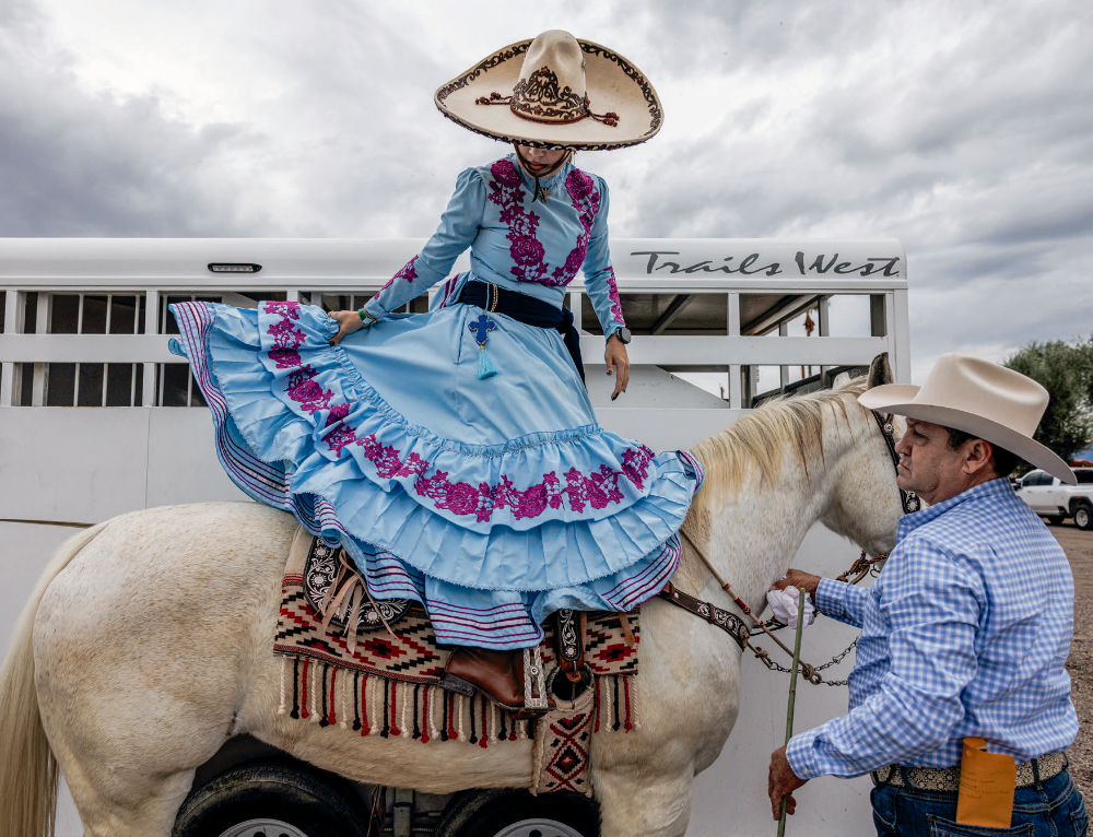 Beneath a cloudy sky, a member of the Rayenari team saddles up ahead of a November event, the Torneo del Desierto, at Rancho Corona. Like Amazonas de Corazón, Rayenari has several members from the same family.
