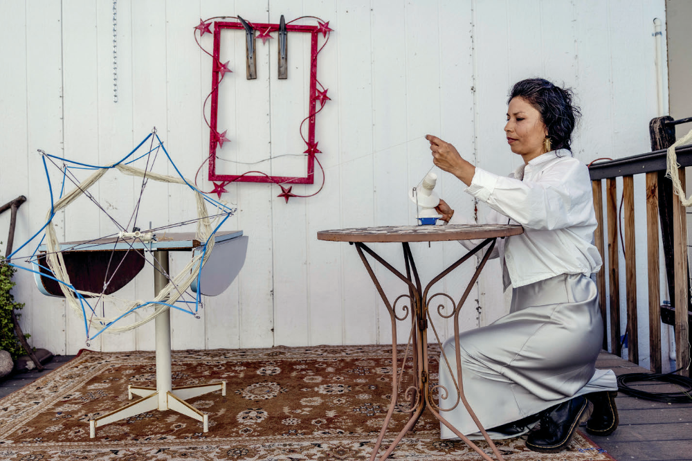 Martinez-Granados works with dyed thread at her studio. She says she hopes her work inspires a sense of connection, particularly for other immigrants.