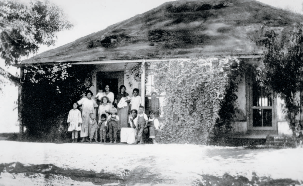 The Elias family poses for a photo in front of the family’s house, one of many built on land that Manuela Sánchez Sotelo subdivided from her homestead. Tempe History Museum