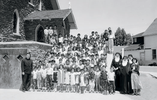 Students pose in front of Our Lady of Guadalupe Chapel in May 1954