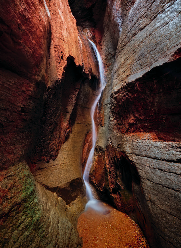 A thin waterfall cascades in Saddle Canyon, near river Mile 47 on the Colorado. | ADAM SCHALLAU