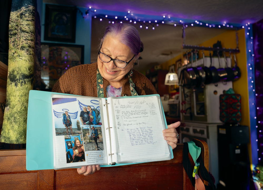 Mary Jo Kvidera, another angel, displays a scrapbook of her experiences with thru-hikers.
