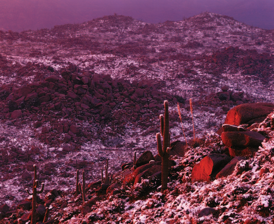 The morning sun plays across the spiky armament of cholla and saguaro cacti in Organ Pipe Cactus National Monument. Rising abruptly in the background, the shadowed face of the Ajo Range provides a convergence of moody grandeur. The vermilion glow of sunset filtered through a receding storm paints the Mazatzal Mountains an eerie shade of winter in central Arizona.