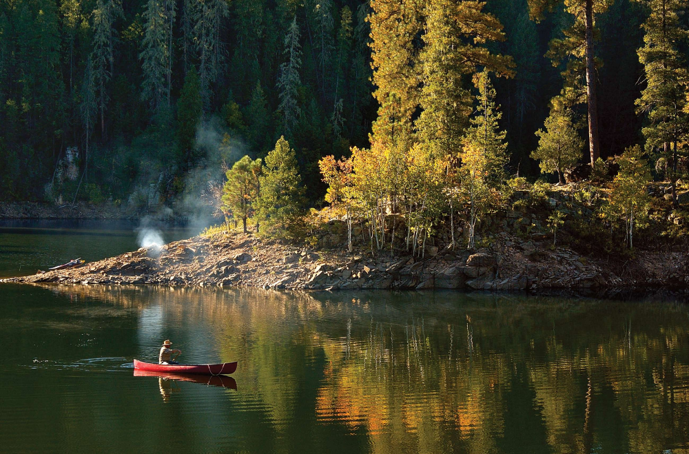 In Nature's Lap Author Tom Carpenter glides along in his prized red canoe on a languid Blue Ridge Reservoir on October 1.