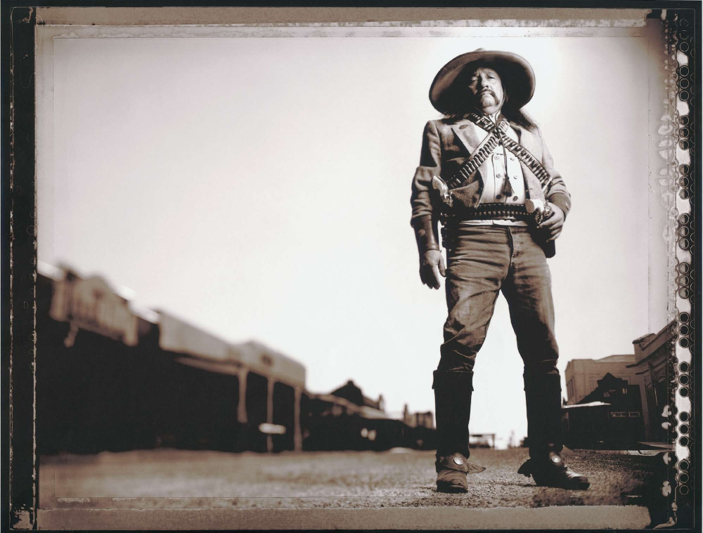 Joe Muñoz, a gunfight re-enactor in Tombstone, poses on October 1 as gritty Filemeno Orante, his favorite Wild West villain. Muñoz has been getting "gunned down" for 10 years-which is just the way he likes it.
