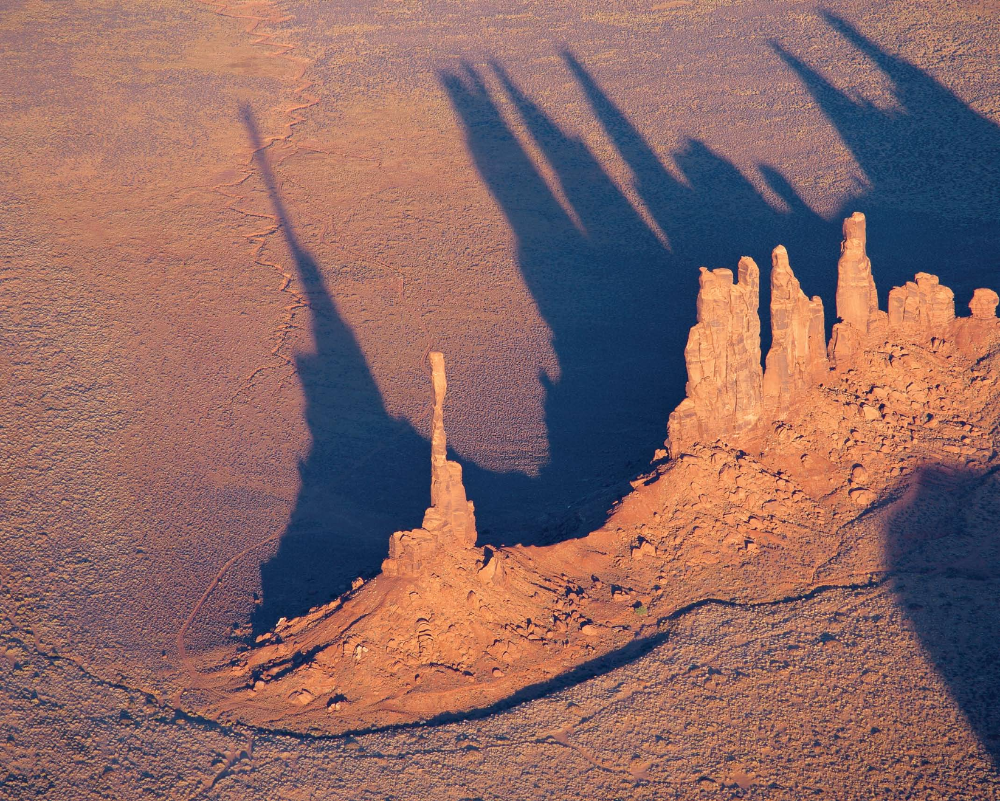 "Shadows come to life when seen from the air, sometimes
stealing the show from the main subject. I can maneuver
in my little airplane to find just the right altitude and
distance to frame the Yei Bichei formation [right] and
Totem Pole [center] in their own shadows. "
