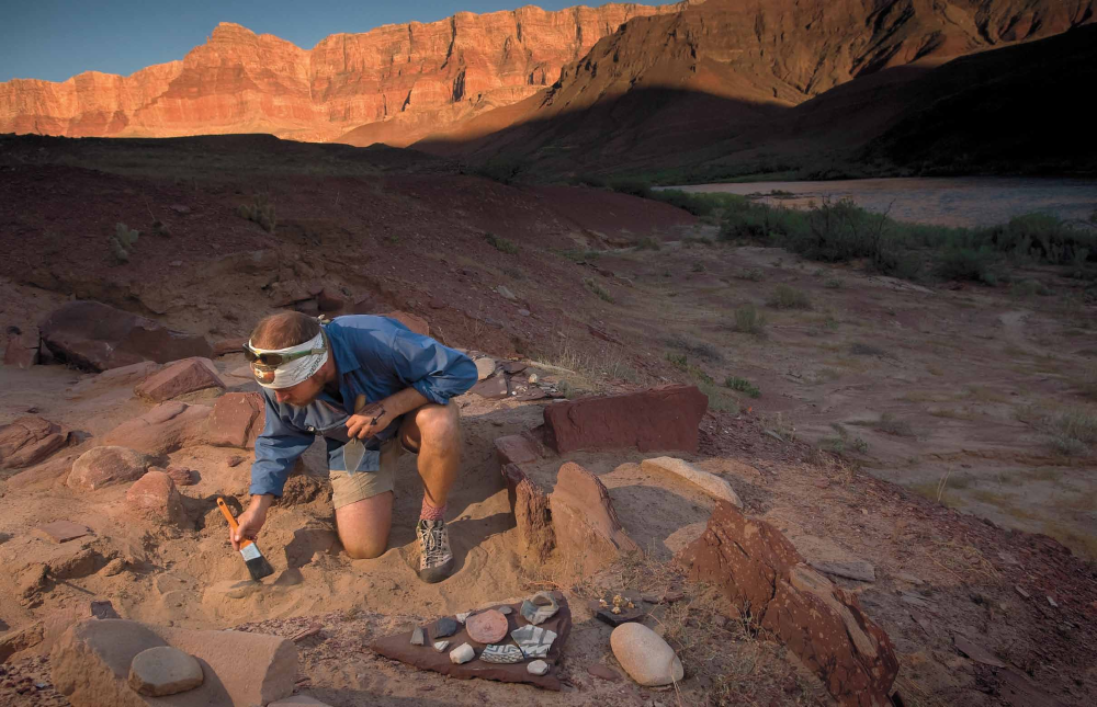 Freelance archaeologist Tim Gibbs brushes away the fine sand at Furnace Flats.