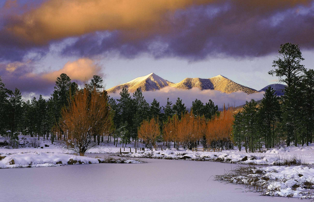 The snow-cloaked San Francisco Peaks loom over a wintry landscape near Flagstaff.