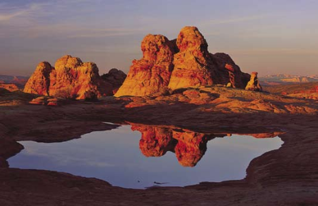 Red sandstone formations on the Colorado Plateau are the main attraction for the recurring encounters of two world travelers.