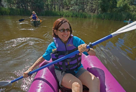 During paddle class, soon-to-be outdoors woman Baker (left) maneuvers a whitewater-quality inflatable kayak, also known as an IK, while other participants try their hands at an open canoe and a hard-shell kayak.