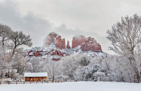 Cathedral Rock towers over a snowy landscape at Crescent Moon Ranch, a historic homestead in Sedona that now serves as a day-use area and picnic site.