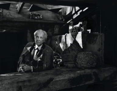 Frank Lloyd Wright - photographed here at Taliesin West, his winter home from the late 1930s to his death in 1959-seldom appeared without his immaculate suit and tie, and he sometimes wore a cape as well. He cultivated this theatrical image as carefully as he designed the entry sequences to his buildings.