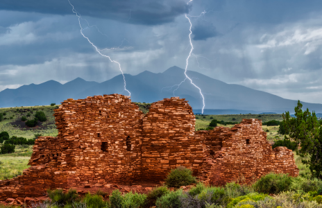 Lightning strikes between the distant
San Francisco Peaks and Lomaki Pueblo
at Wupatki National Monument, located
northeast of the Peaks.