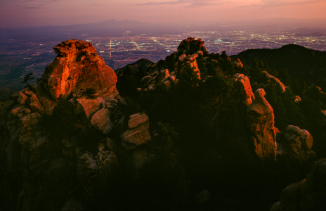 The lights of the Tucson area glow beneath the summit of the Santa Catalina Mountains' Cathedral Rock.