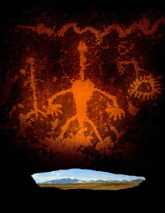An opening beneath a petroglyph panel frames a view of the San Francisco Peaks near Flagstaff.