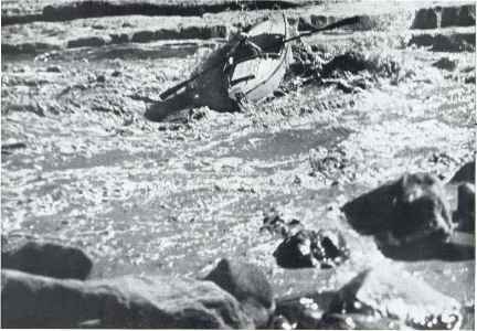 Merril Spencer, third boatman, pilots his craft through Badger Rapids. He appears to be in difficulty, as the boat is swept, out of control, down the plunging current. No damage was done, however, and the expedition went through without an upset.