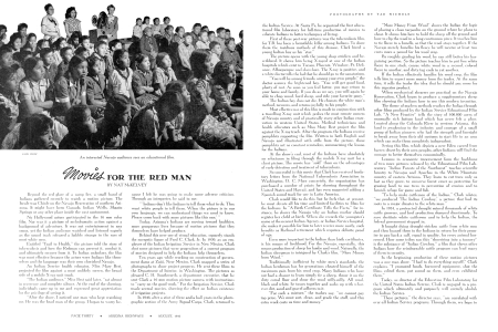 An interested Navajo audience sees an educational film.