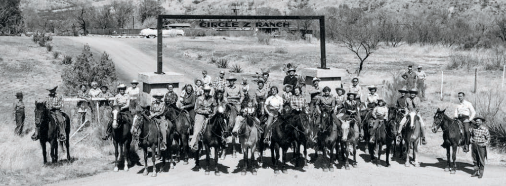 Circle Z Ranch employees and guests pose in front of the ranch's entrance in a photo from around 1950.