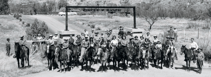 Circle Z Ranch employees and guests pose in front of the ranch's entrance in a photo from around 1950.